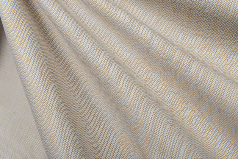 Tessuto in lino beige della gamma Colmar, piegato in morbide onde